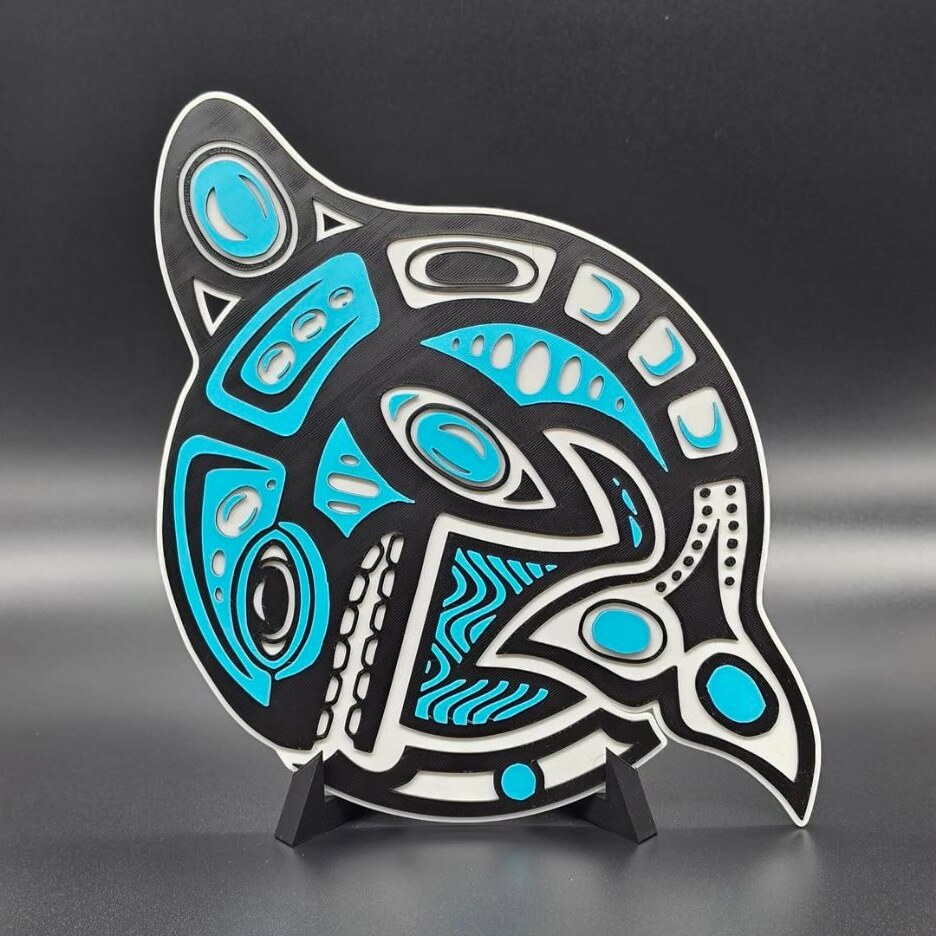 Black, white, and turquoise dimensional orca art